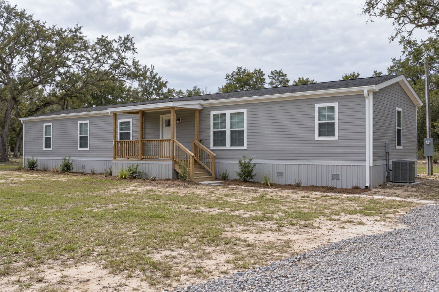 Realistic concept of the Harbor 1152 coastal-grey single-wide mobile home on a Gulf Coast inland homesite