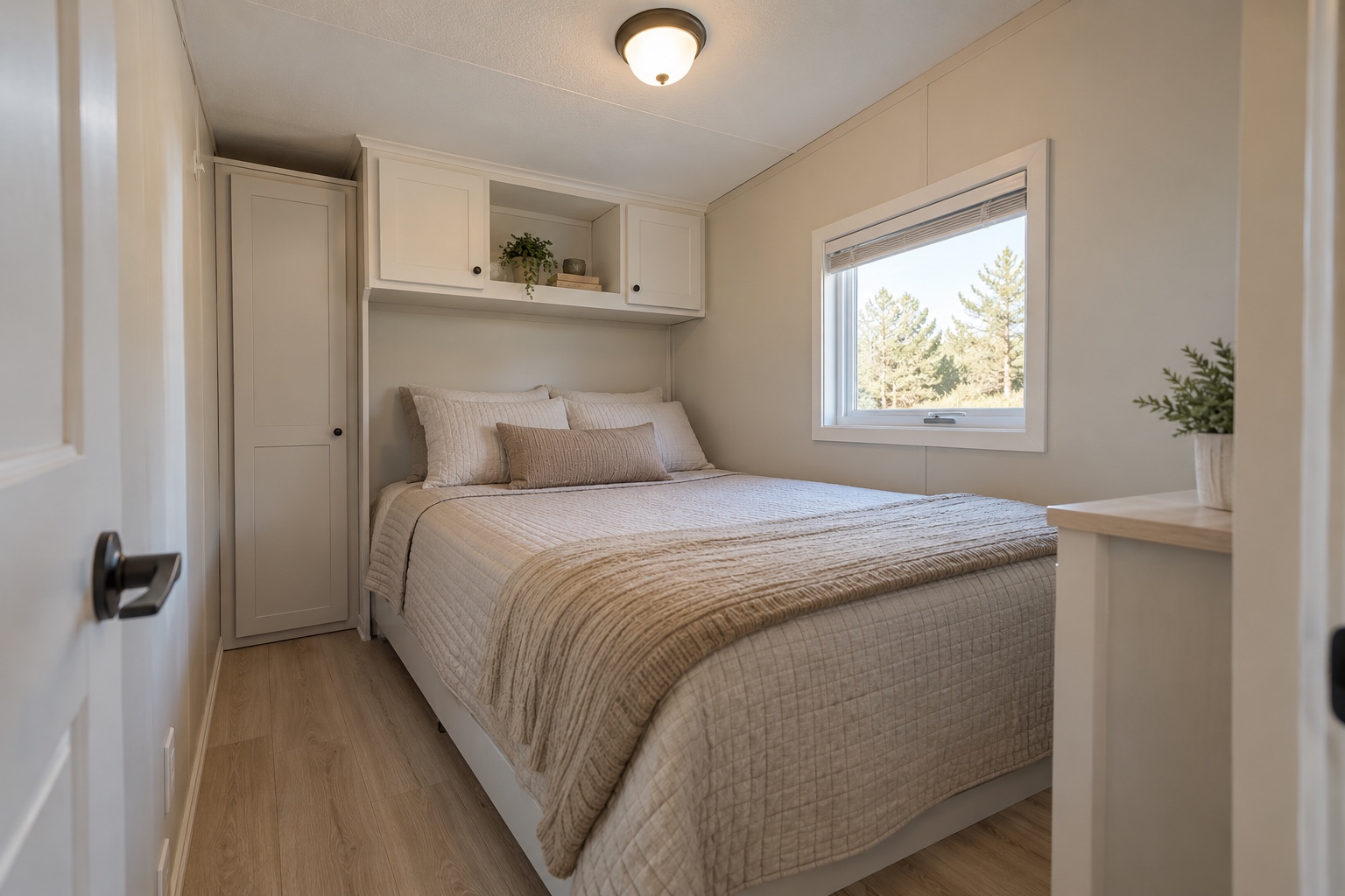 Very compact rear bedroom with full bed, shallow wardrobe and overhead storage inside the Haven 304