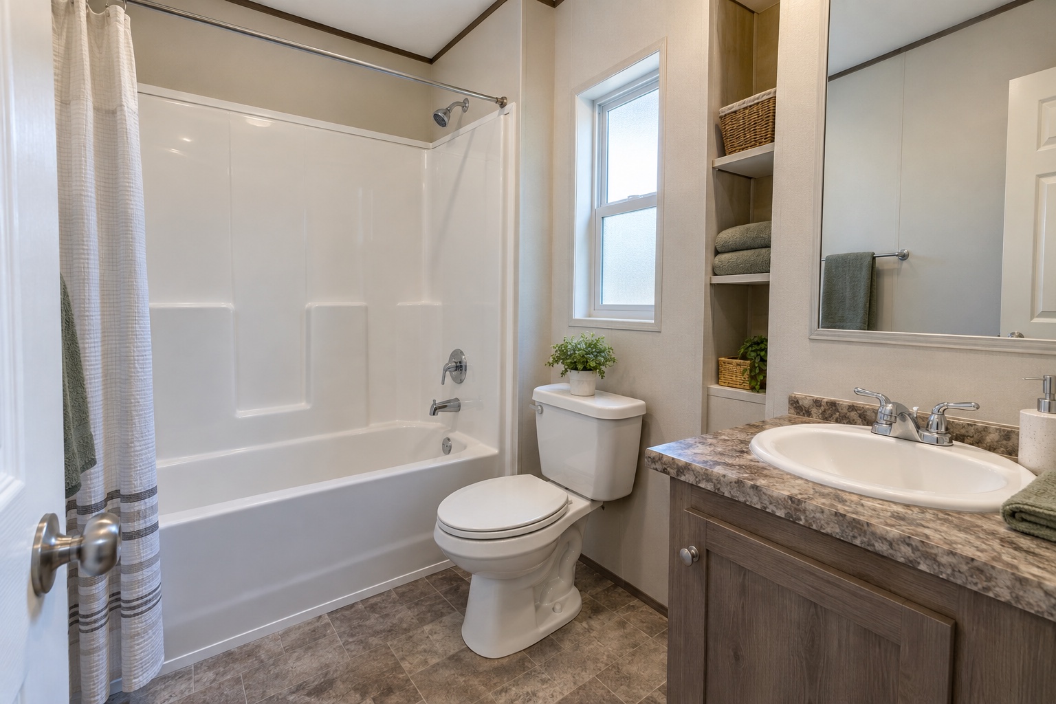 Economical bathroom with tub-shower and laminate vanity inside the Timber 352 mobile home