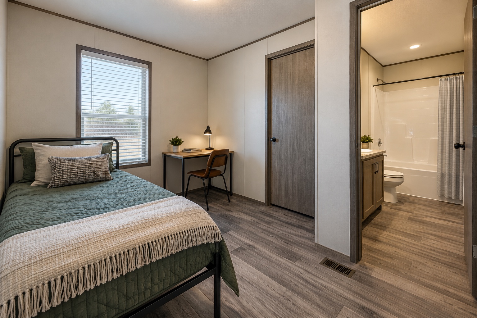 Secondary bedroom and adjacent hall bathroom inside the Trailside 924 single-wide