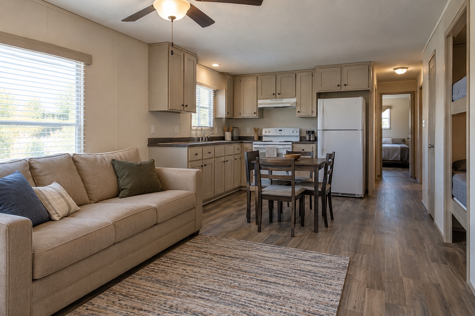 Realistic open living room, economical kitchen and small bunk-room entry inside the Transit 448 mobile home